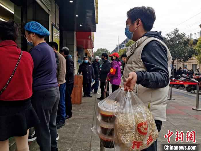 长时间没有品尝到牛肉面,一居民打包多份回家 胡传林 摄 襄阳战“疫”记:一碗牛肉面再现古城“烟火气”